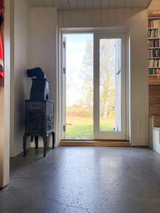 an empty room with a stove and a window at Architect-Designed House With Pier In Ny Hellesund in Søgne +13 photos