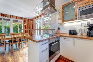 a kitchen with white cabinets and a stove top oven at Küstenhaus Koserow in Koserow