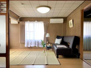 a living room with a couch and a window at 宇佐神宮近く- 神さまと仏さまと kamisama to hotokesama to in Nagasu