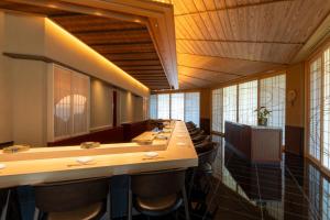 a large room with a long row of tables and chairs at PGM Hotel Resort Okinawa in Onna +202 photos