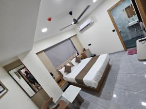 a bedroom with a large bed in a room at Hotel Royal Heritage in Gandhinagar