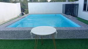 a small swimming pool with a stool in front of it at Rembulan Guesthouse in Mersing