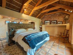 a bedroom with a large bed and a brick wall at Chalcedony in McGregor +61 photos