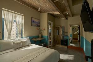 a bedroom with a large white bed and a window at TONG Boutique Hotel in Phan Thiet
