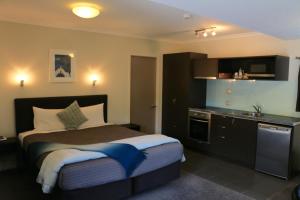 a hotel room with a bed and a sink at Abaco on Jervois in Auckland