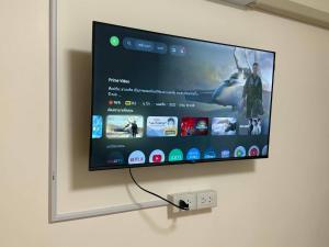 a flat screen tv hanging on a wall at Kasalong stay in Ban Nong Chaeng