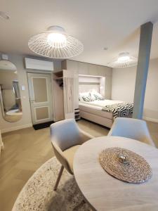 a room with a bed and a table and chairs at Arte Güldenstubbe Residences in Kuressaare +19 photos
