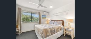 a bedroom with a bed and a window at Terrapin Apartment 4 in Noosaville