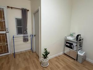 an empty room with a room with a plant in it at Kasalong stay in Ban Nong Chaeng +4 photos