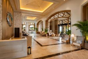 a lobby of a hotel with a living room at PGM Hotel Resort Okinawa in Onna