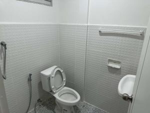 a bathroom with a toilet and a sink at Kasalong stay in Ban Nong Chaeng