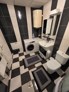 a black and white bathroom with a toilet and a sink at Struga Alpha House in Struga
