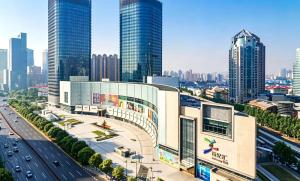 a view of a building in a city with tall buildings at Shanghai Qilu Hotel in Shanghai