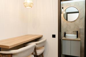 a dining room with a table and chairs and a mirror at Flowers House Sibiu in Sibiu +87 photos