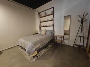 a bedroom with a bed and a table and a tripod at Casa Tabacalera in Mexico City +2 photos