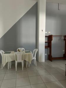 a dining room with a table and chairs and a piano at Misha Home Nro 732 in Puerto Ayora