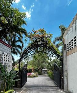 an entrance to a garden with an archway at Commander Suites de Velada in Antipolo
