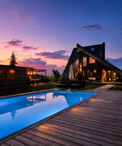 a house with a swimming pool in front of a house at Zoe Luxury House in Gomirje