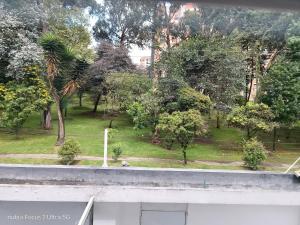 a view of a park with trees and grass at Room cerca al aeropuerto #3 in Bogotá