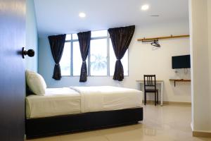 a bedroom with a bed and a window at Orkid Inn Kajang in Kajang