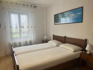 a bedroom with two beds and a tv on the wall at Martin in Trento