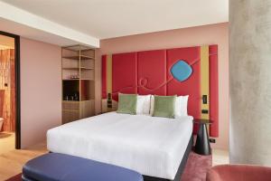 a bedroom with a white bed and a red wall at Quincy Hotel Melbourne in Melbourne +61 photos