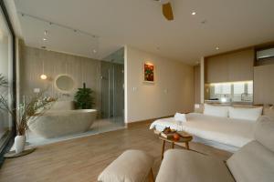 a bedroom with a large bed and a bath tub at Elora House in Thôn Lại Thê +60 photos