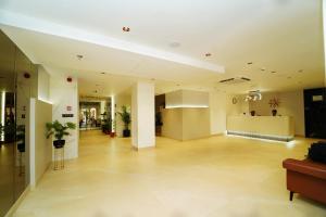 a lobby of a building with a waiting room at The Saffron Hotel in Bhubaneshwar