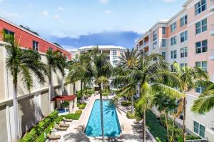 an overhead view of the pool at a resort with palm trees at Moorings Pool Overview Resort in Lantana
