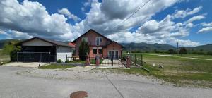 a house with a fence in front of a house at Zlata Apartment in Fužine