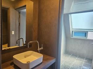 a bathroom with a white sink and a window at Ocean View Haute Hotel in Busan +64 photos