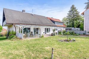 a white house with a large yard in front of it at Zipper Burgblick Otzberg Odenwald in Hering
