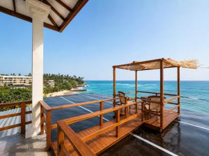 a view of the ocean from the balcony of a resort at Ocean Bliss by Sugar Coliving in Weligama