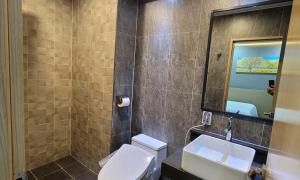 a bathroom with a toilet and a sink and a mirror at Namyangju Benikea JD Hotel in Namyangju +19 photos