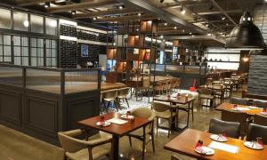 a restaurant with tables and chairs in a room at Namyangju Benikea JD Hotel in Namyangju