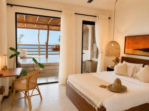 a bedroom with a bed and a view of the ocean at Ocean Bliss by Sugar Coliving in Weligama