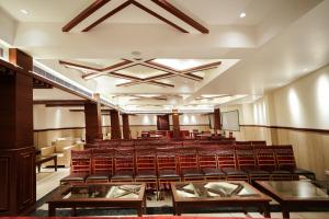 an empty lecture hall with chairs and tables at The Altruist Katra Hotel in Katra