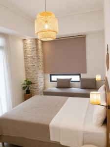 a bedroom with a large bed and a large window at Lithos in Palaiochora