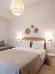 a bedroom with a bed and a chandelier at Lithos in Palaiochora +47 photos