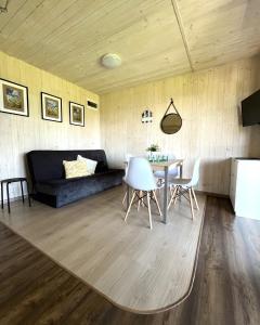 a living room with a couch and a table at Domki Selma in Władysławowo