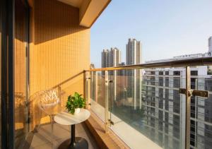 a balcony with a table and a view of a city at Dan Executive Apartment Guangzhou Zhujiang New Town in Guangzhou