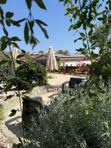 a patio with an umbrella and chairs and a building at Kassandra's Cottage in Vasa