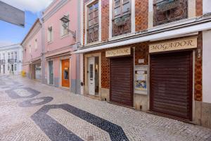 a street with two garage doors on the fronts of buildings at Casa Miclá in Lagos