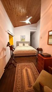 a bedroom with a bed and a wooden ceiling at Kassandra's Cottage in Vasa
