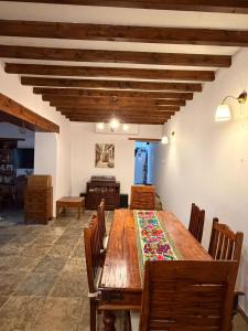 a dining room with a wooden table and chairs at Kassandra's Cottage in Vasa