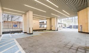 an empty lobby of a building with columns and lights at Uiwang Milos Hotel in Uiwang