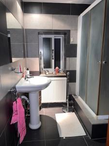 a bathroom with a sink and a mirror at Kassandra's Cottage in Vasa +19 photos
