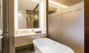 a bathroom with a sink and a toilet and a mirror at Uiwang Milos Hotel in Uiwang +30 photos