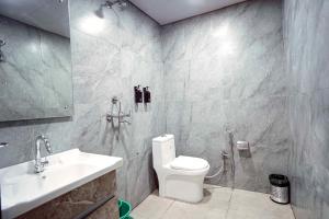 a bathroom with a white toilet and a sink at Hotel Konark INN in Bareilly +15 photos