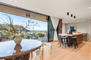 a kitchen and dining room with a table and chairs at Casa Celeste, Grand Architectural Residence in Wollongong